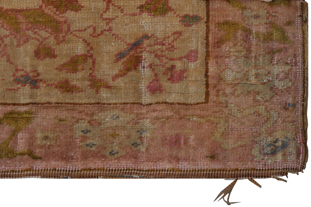 Close-up of an antique rug with intricate patterns and colors.