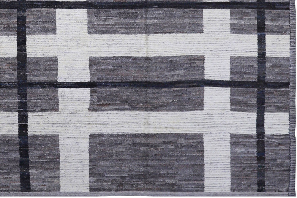 Rug with geometric pattern of black, gray, and white squares