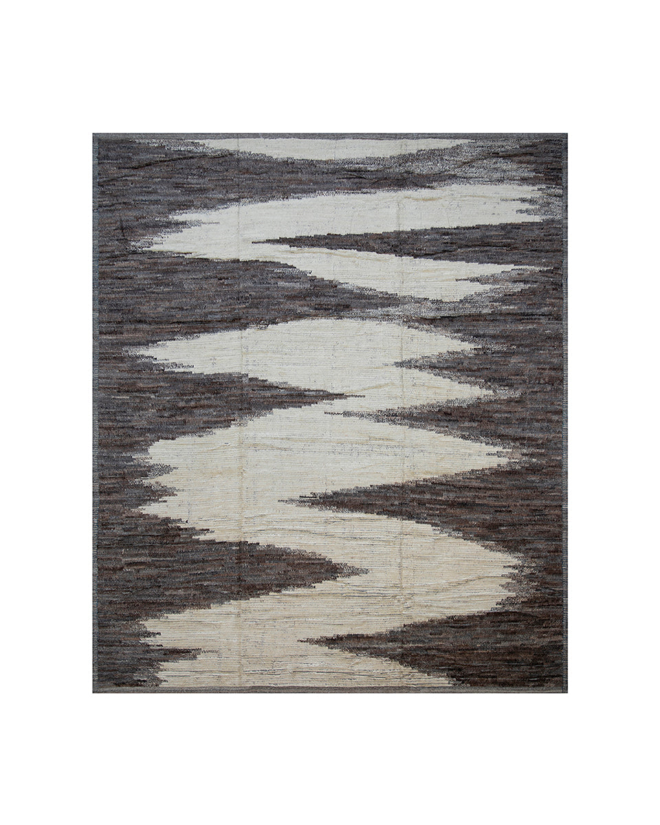Gray and white abstract patterned rug on a white background