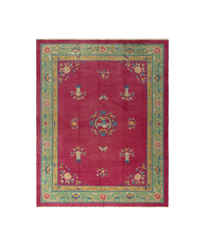 Decorative rug with a red center and colorful border on a white background