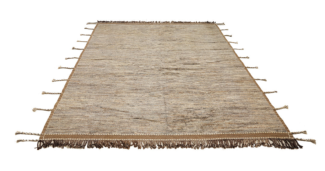 Beige rug with tassels on a white background