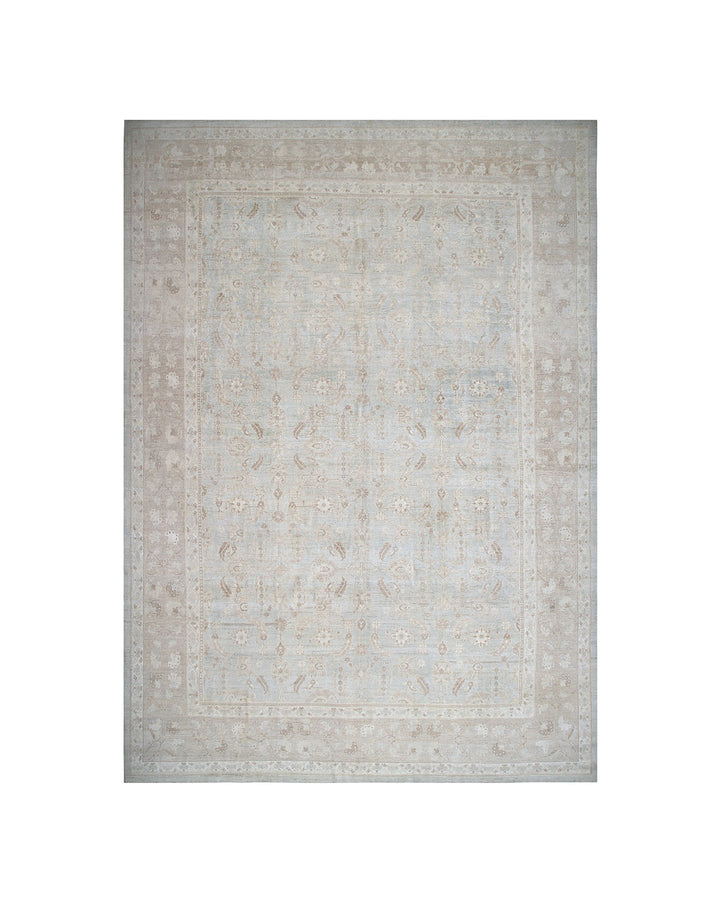 Beige area rug with a subtle pattern on a white background