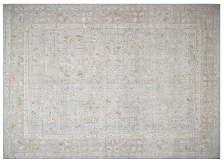 A square area rug with a distressed traditional pattern in soft beige, cream, and light gray tones.