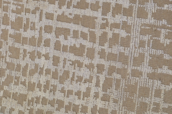 Textured fabric with a geometric pattern in beige and brown tones.