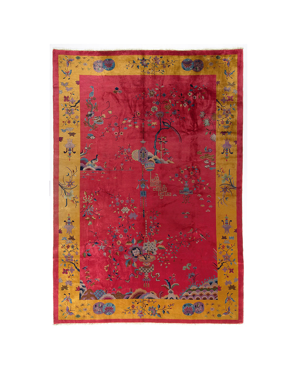 Decorative red and yellow rug with intricate patterns on a white background