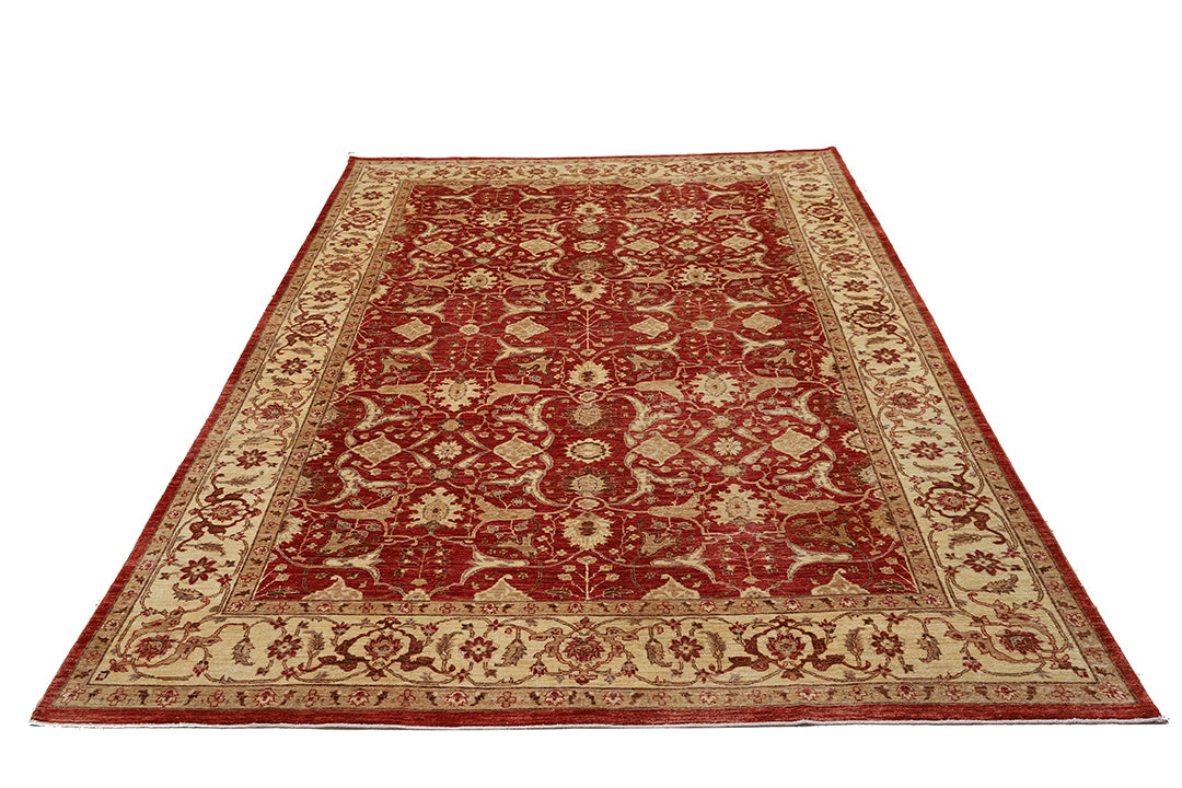 Red and beige patterned rug on a white background