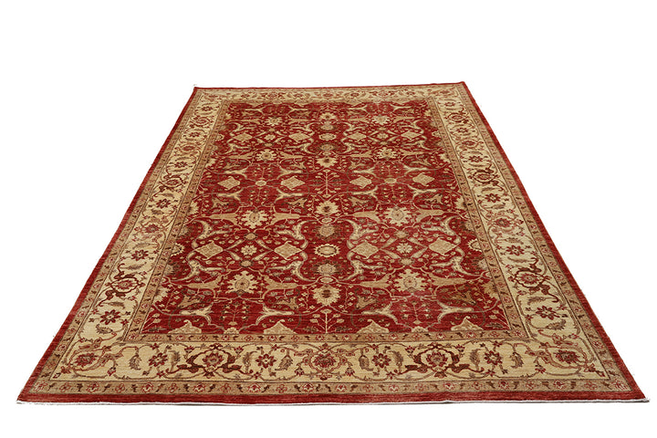 Red and beige patterned rug on a white background