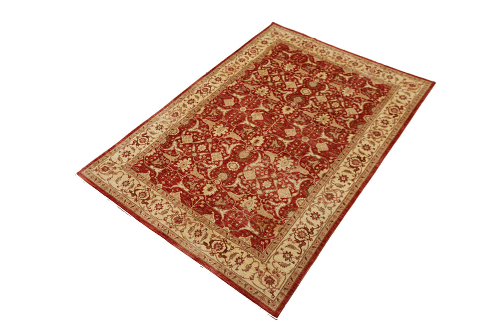 Decorative red and beige patterned rug on a white background