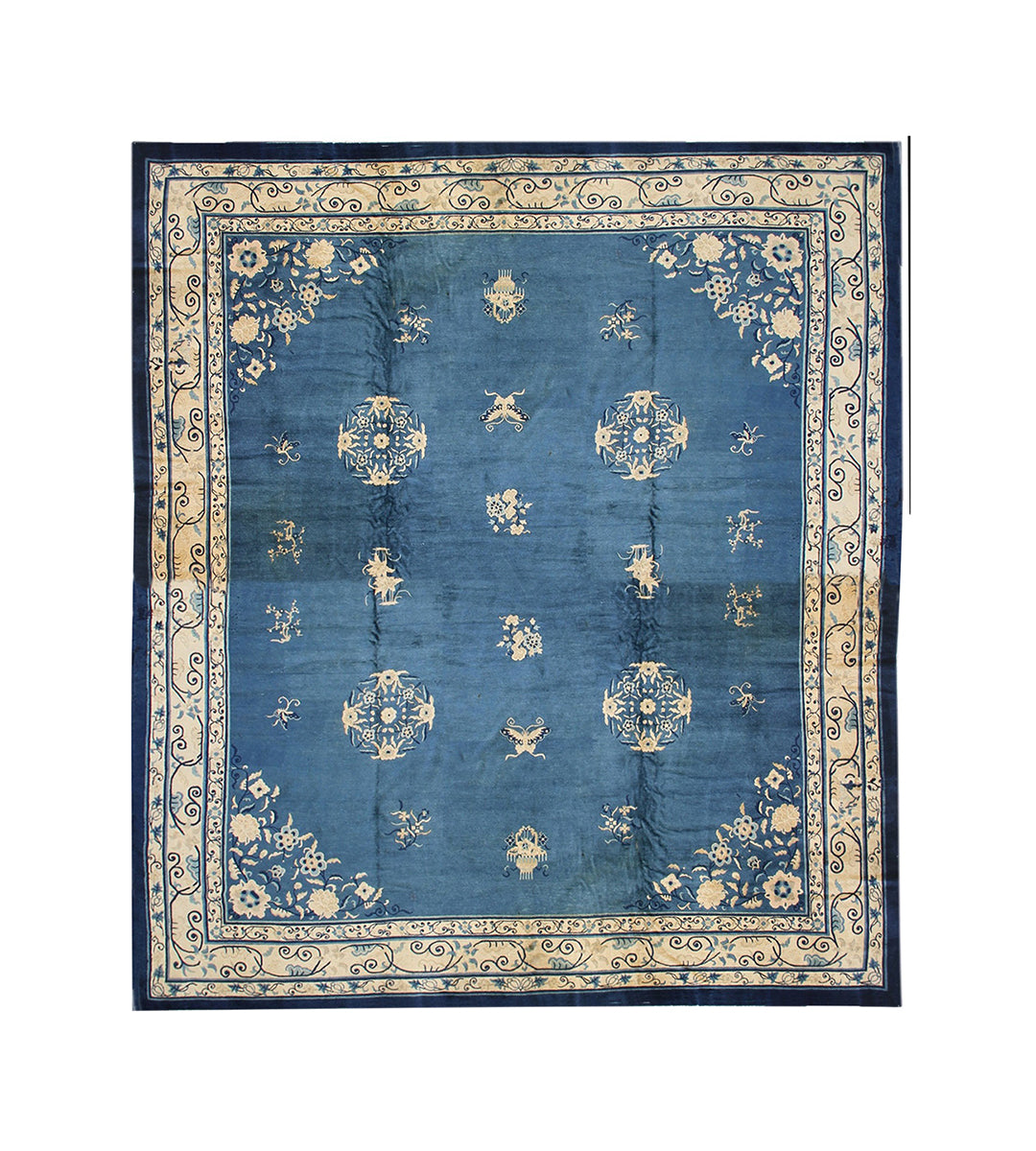 Blue patterned rug with decorative border on a white background