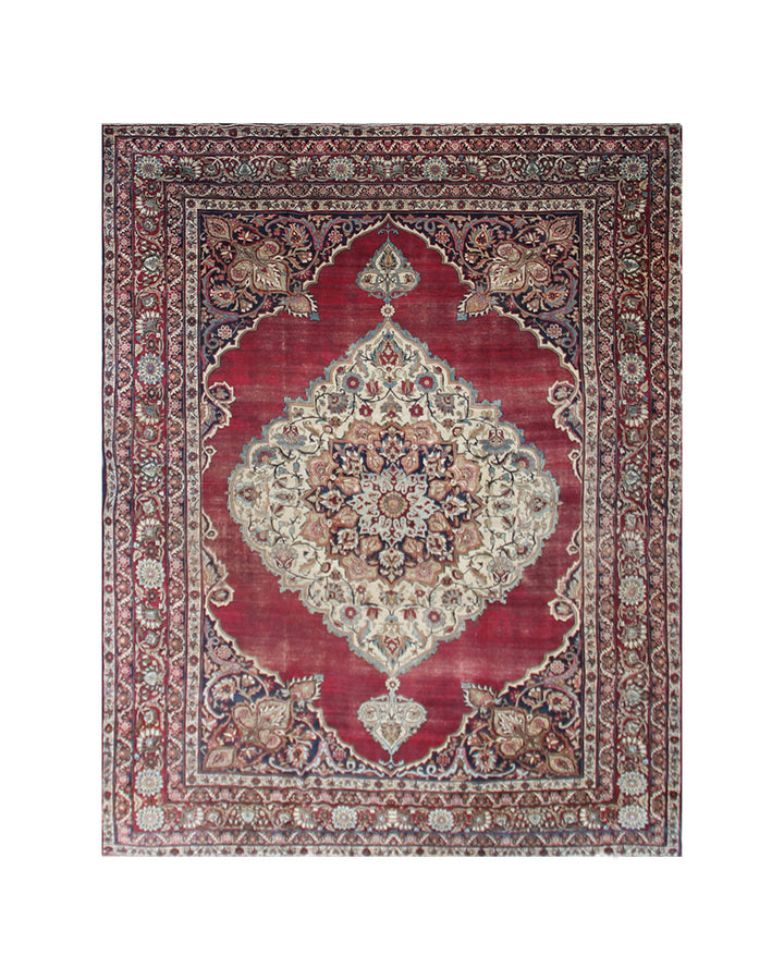 A traditional oriental-style area rug with a deep red field, a large central medallion, and an intricate patterned border in beige, navy, and brown tones, shown flat against a white background.