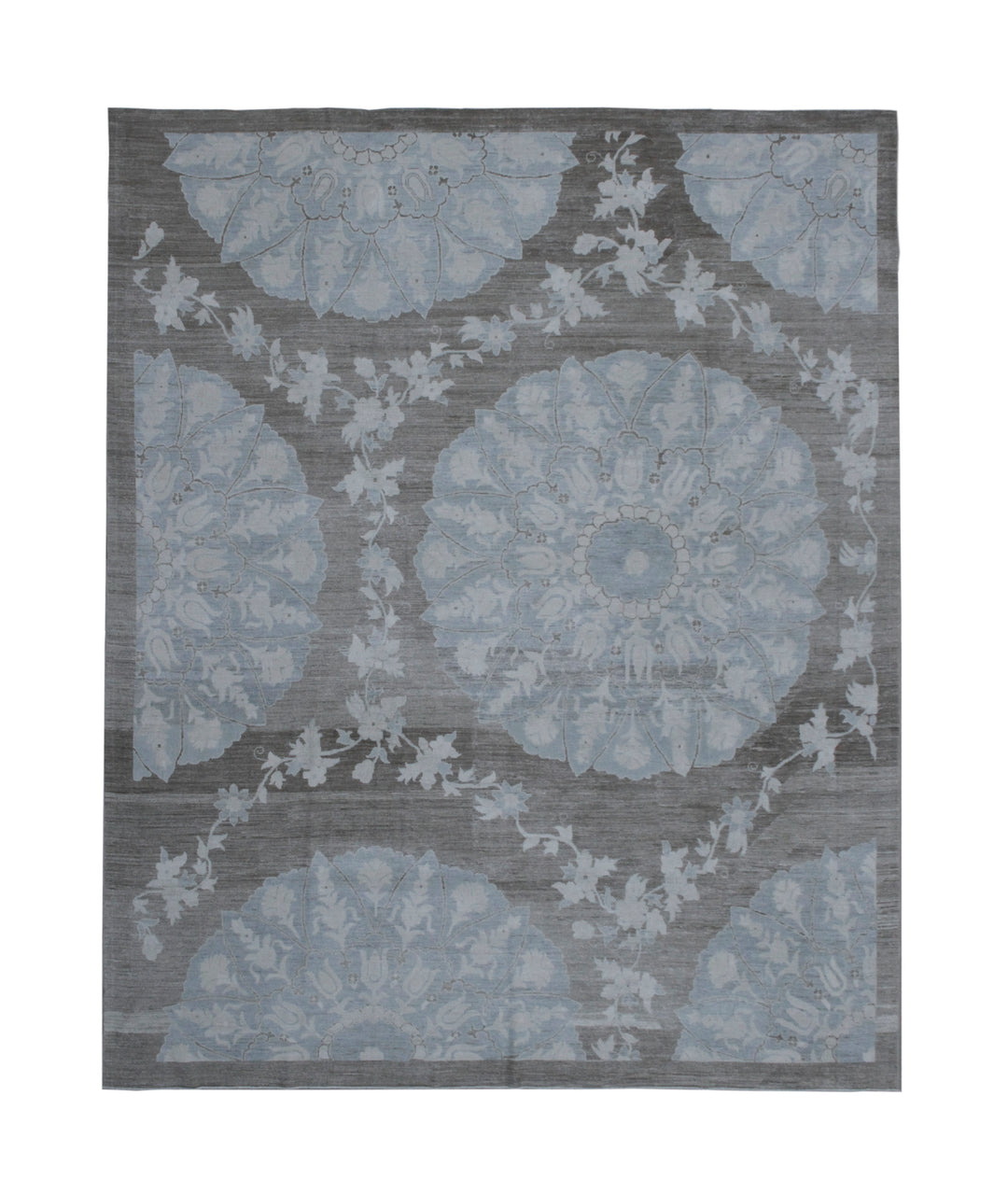 Gray and blue floral patterned rug on a plain background
