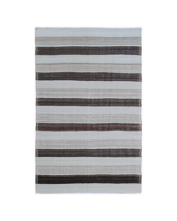 Corner detail showing flat weave construction and natural cotton foundation of cream and brown striped Afghan wool kilim.