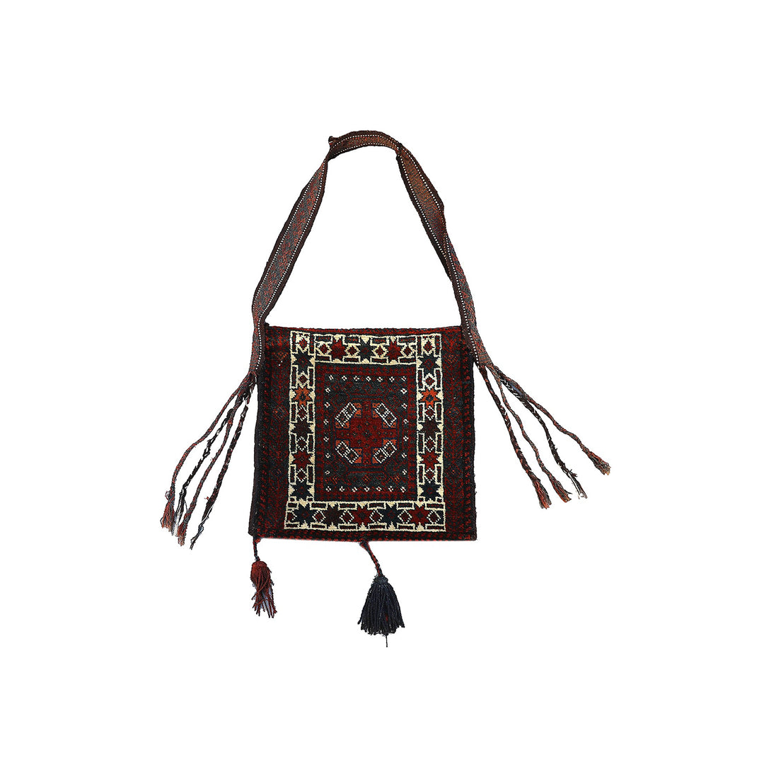 Decorative bag with intricate patterns and tassels on a white background
