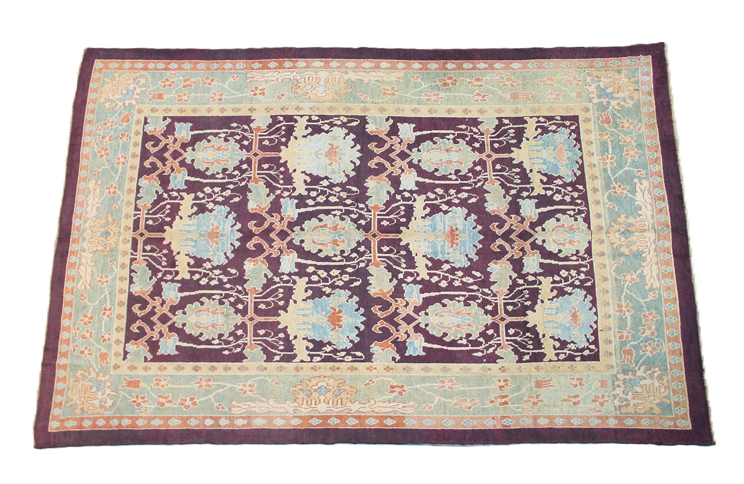 15x10 Dark Brown Burgundy Turkish Ushak rug with ivory and pastel orange Arts and Crafts floral pattern.