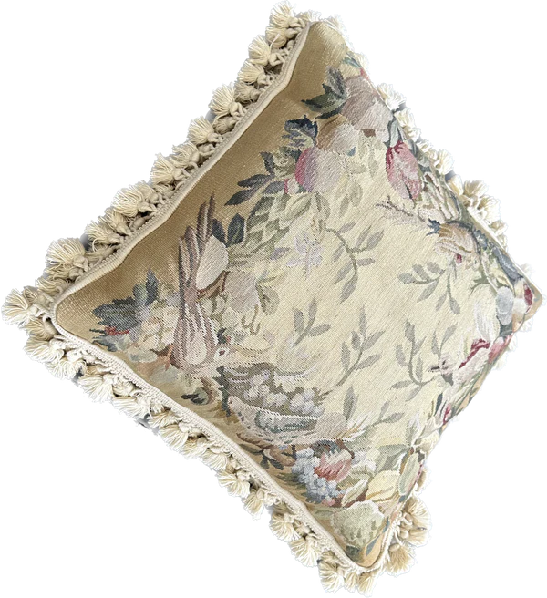 Handcrafted 18x18 cream and tan wool needlepoint cushion with botanical bird motifs and white tassel fringe by Ariana Rugs