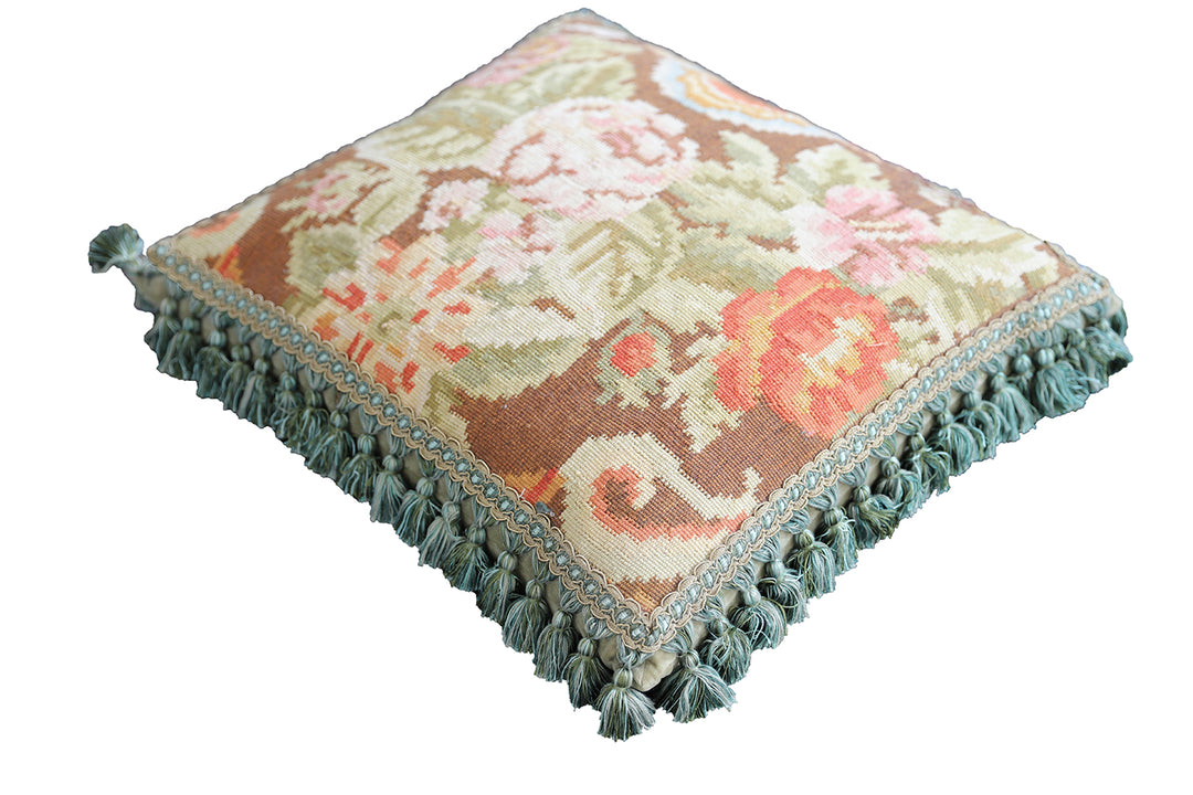 Handcrafted 18x21 brown floral wool accent cushion with white decorative tassels by Ariana Rugs.