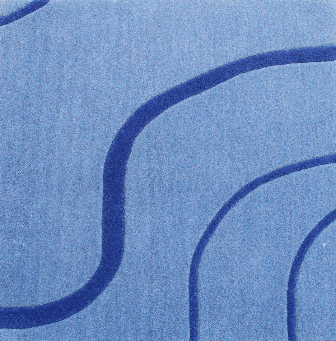 A blue patterned rug with a modern geometric design.