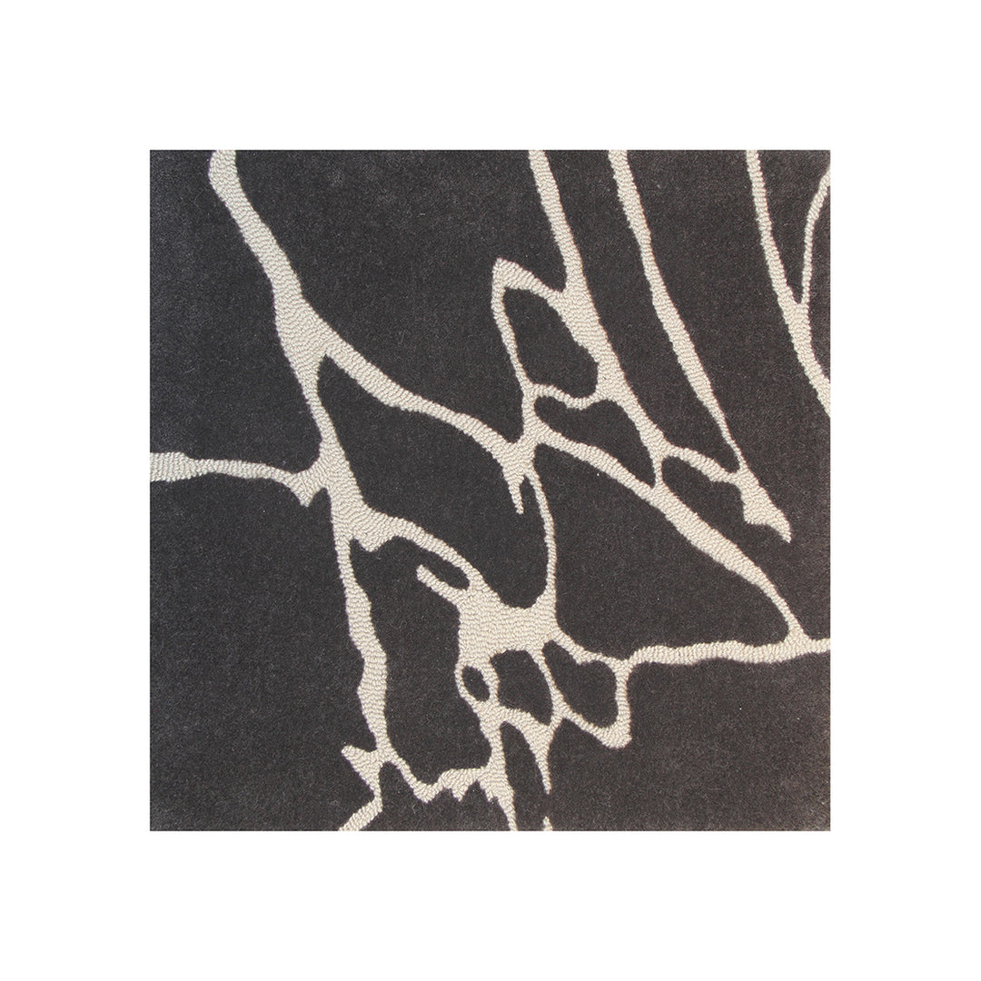 Close-up of a dark gray rug with white abstract leaf patterns