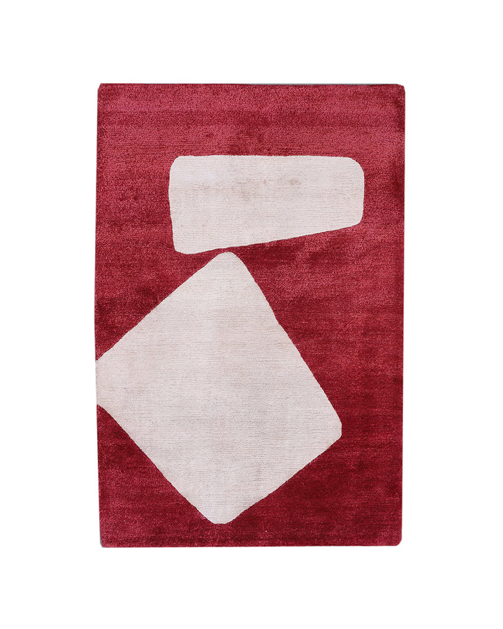 Red rug with white geometric shapes on a white background