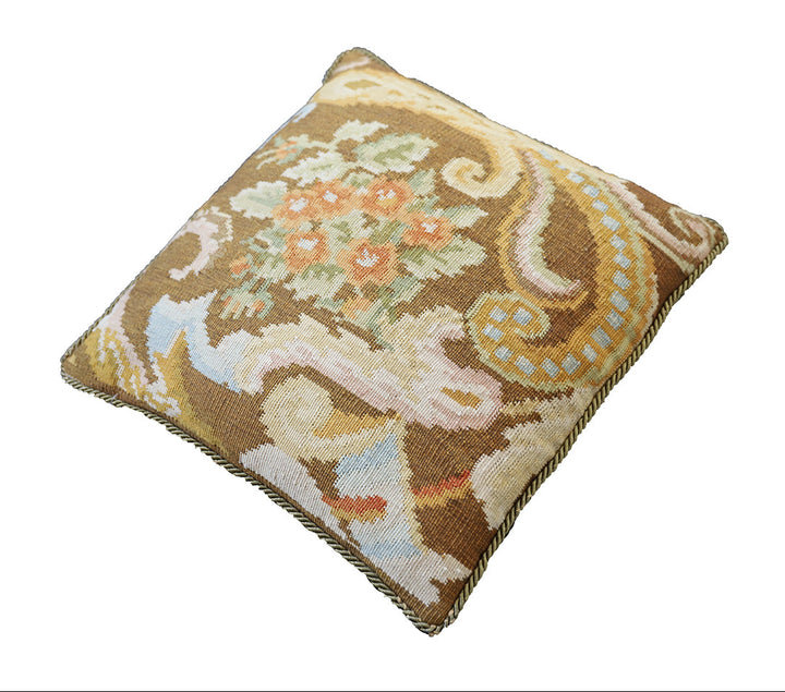 Handwoven brown floral wool cushion cover in warm earth tones by Ariana Rugs.