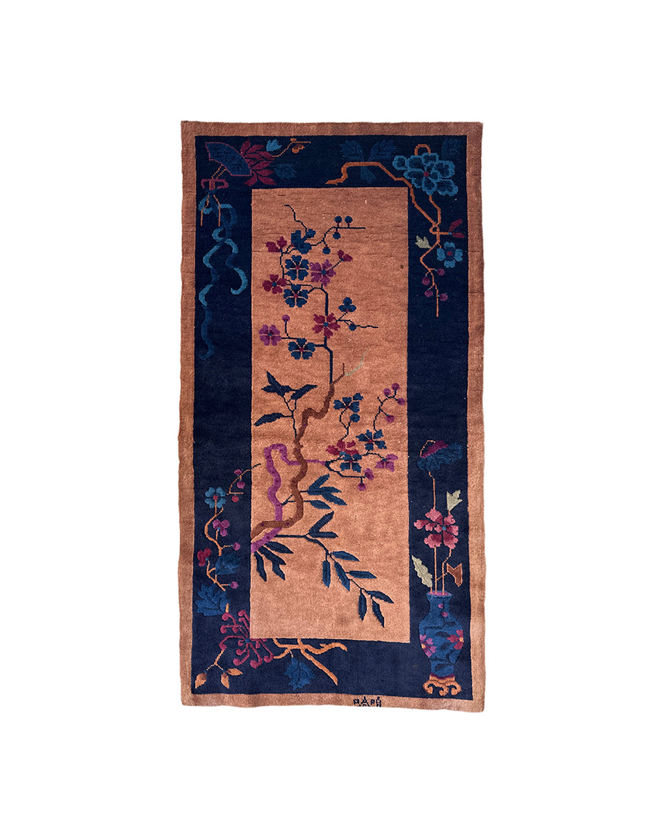 Decorative rug with floral and bird pattern on a white background