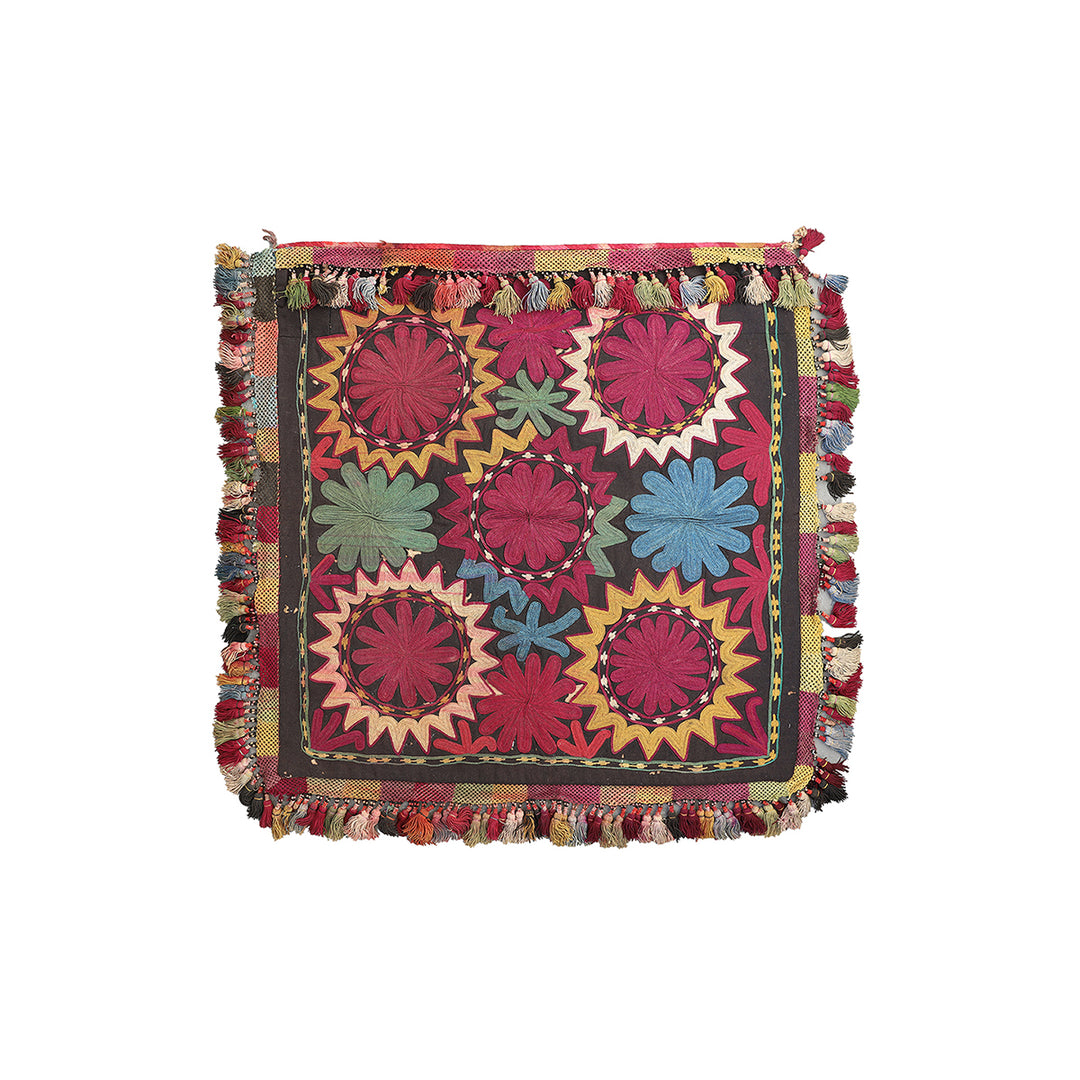 Multicolored embroidered fabric with floral patterns on a white background