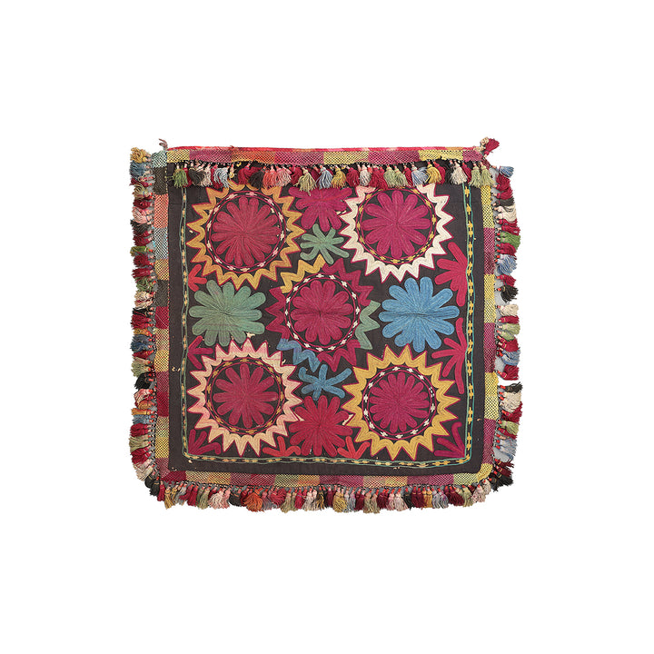 Multicolored embroidered fabric with floral patterns on a white background