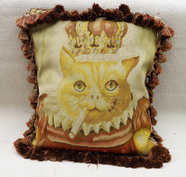 Decorative pillow with a cat wearing a crown on a textured background