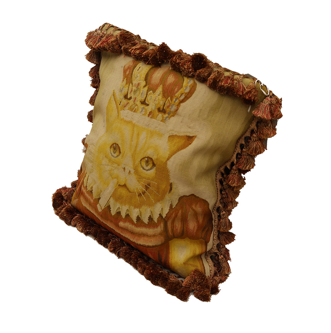 Decorative pillow with a cat design on a gold background