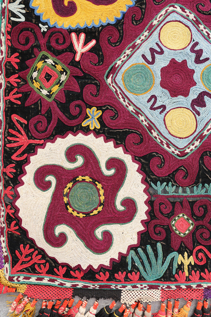 Colorful embroidered fabric with intricate patterns and vibrant colors