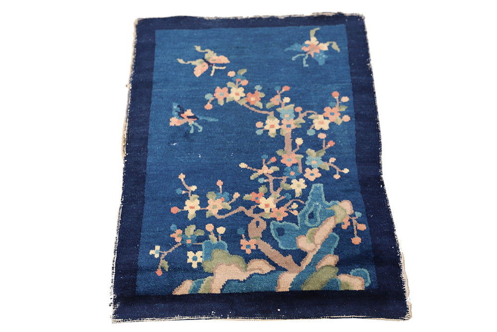 Decorative rug with floral design on a blue background