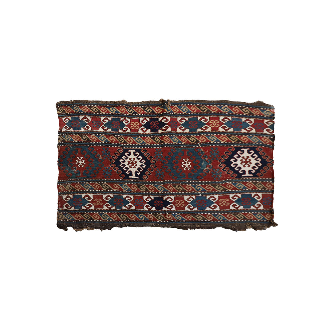 Traditional patterned fabric with geometric designs on a white background