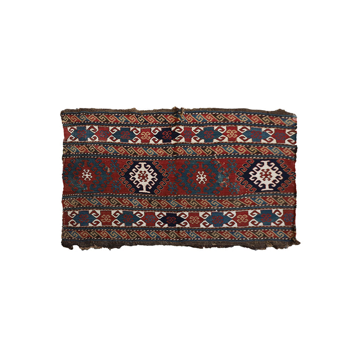 Traditional patterned fabric with geometric designs on a white background