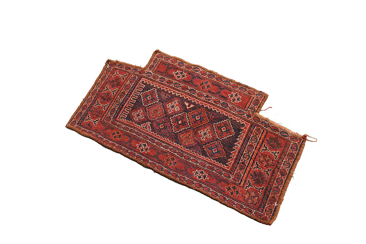 Two red patterned rugs on a white background