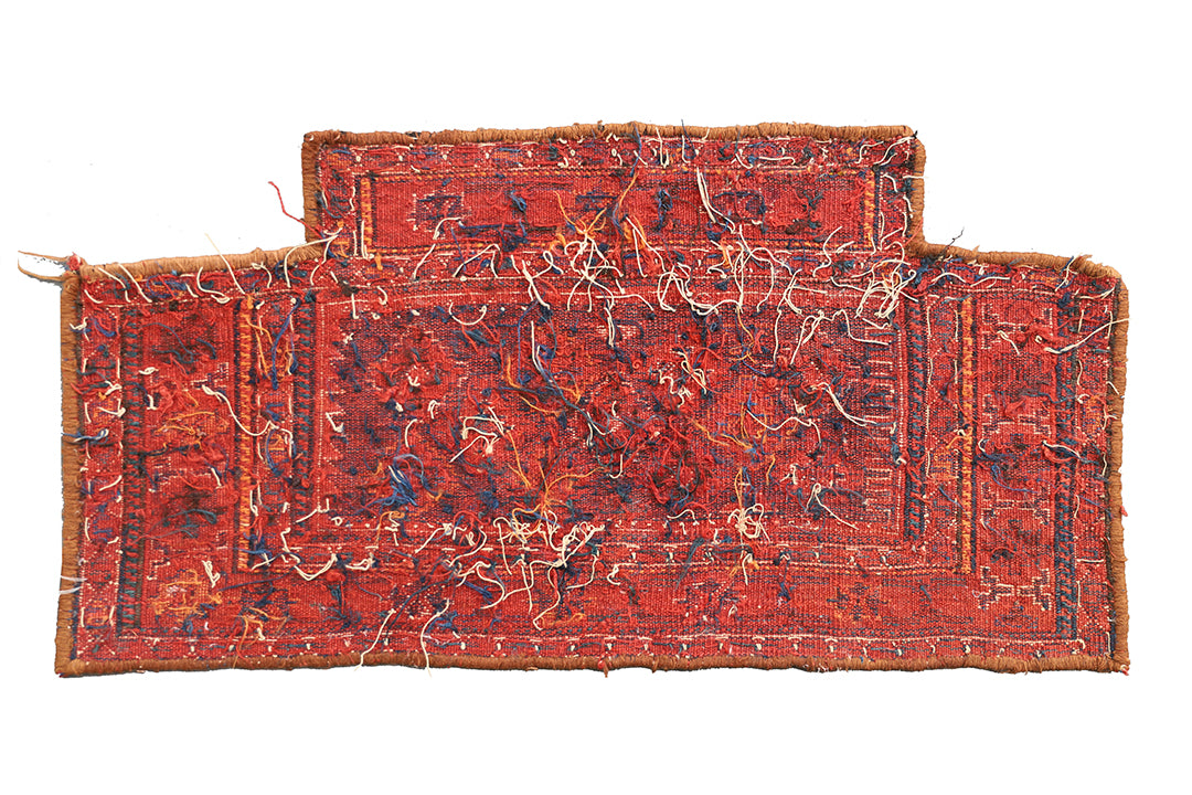 Two red patterned rugs on a white background