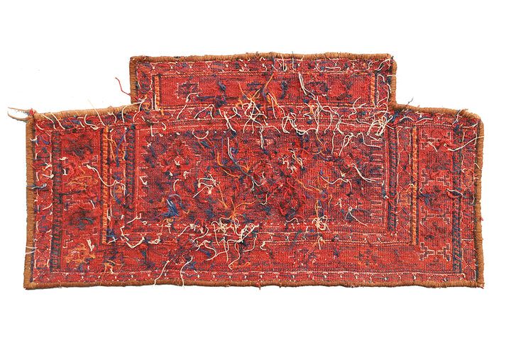 Two red patterned rugs on a white background