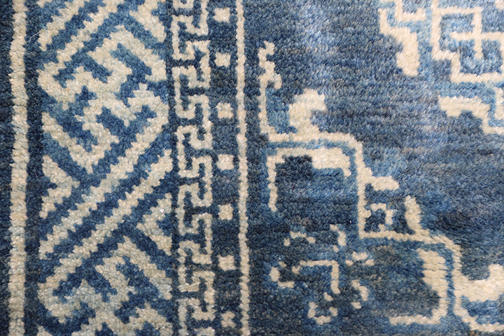 Close-up of a blue and white patterned rug