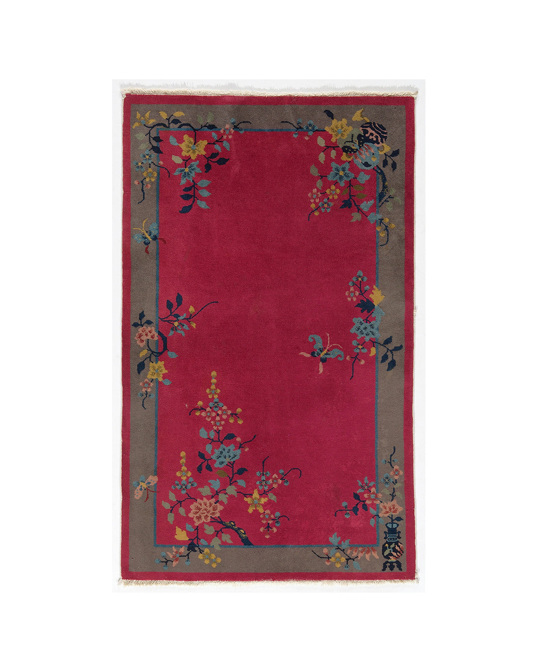 Red rug with floral patterns on a white background