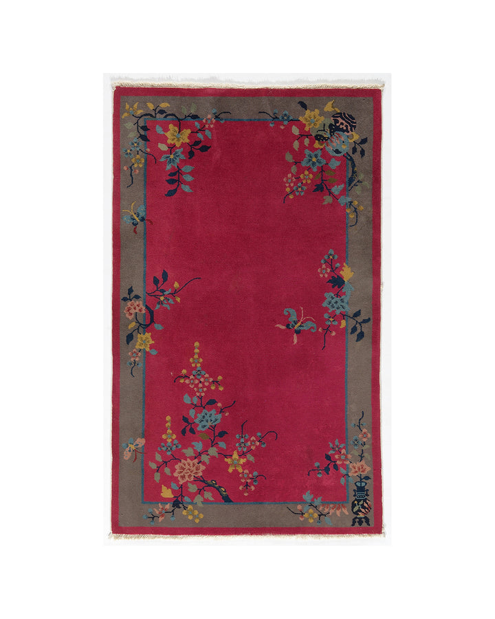 Red rug with floral patterns on a white background
