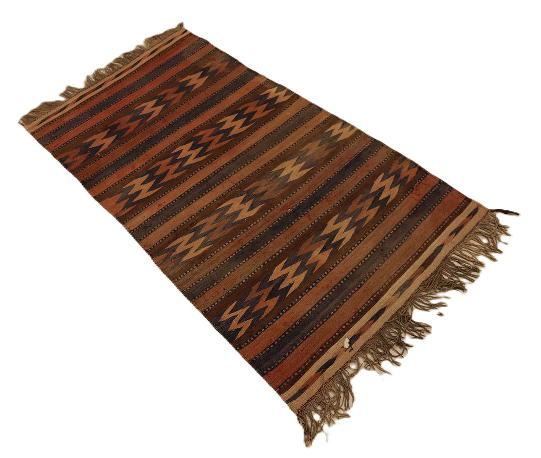 Woven textile with brown and black pattern on a white background
