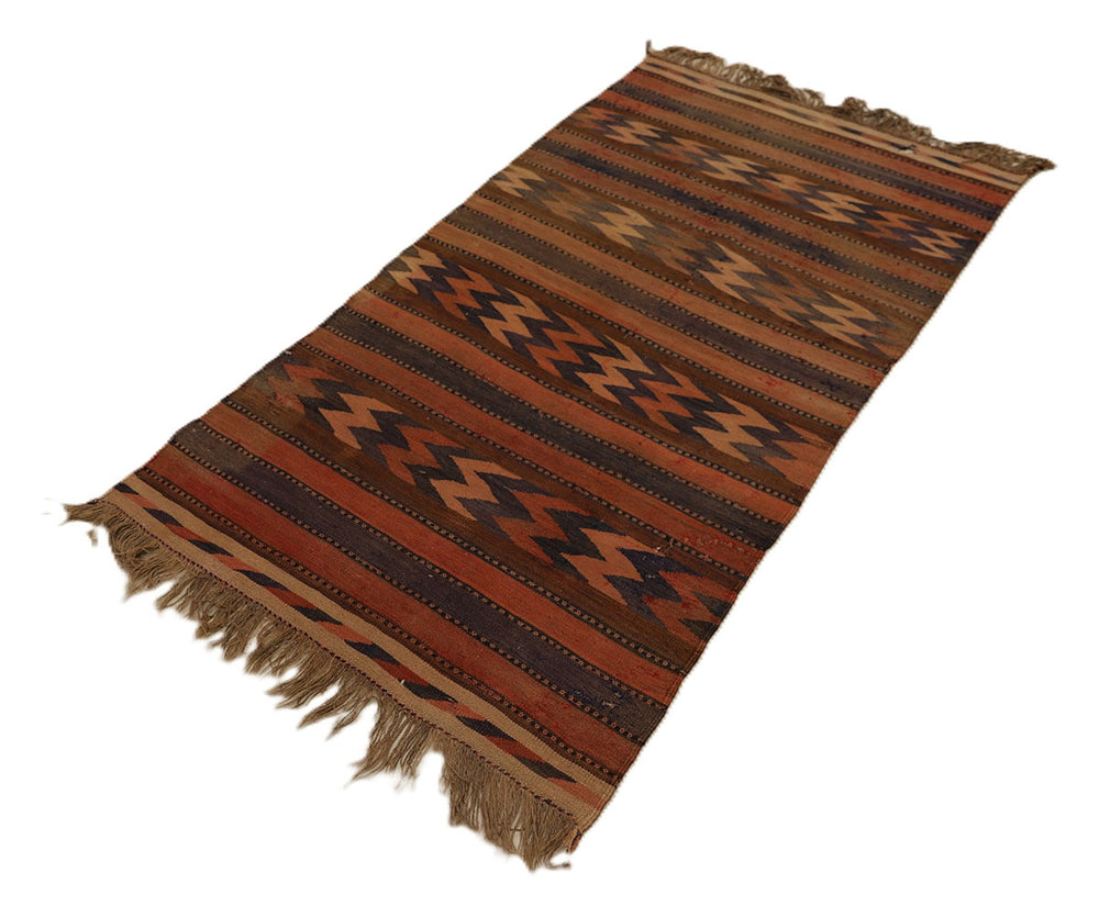 Woven rug with brown and beige pattern on a white background
