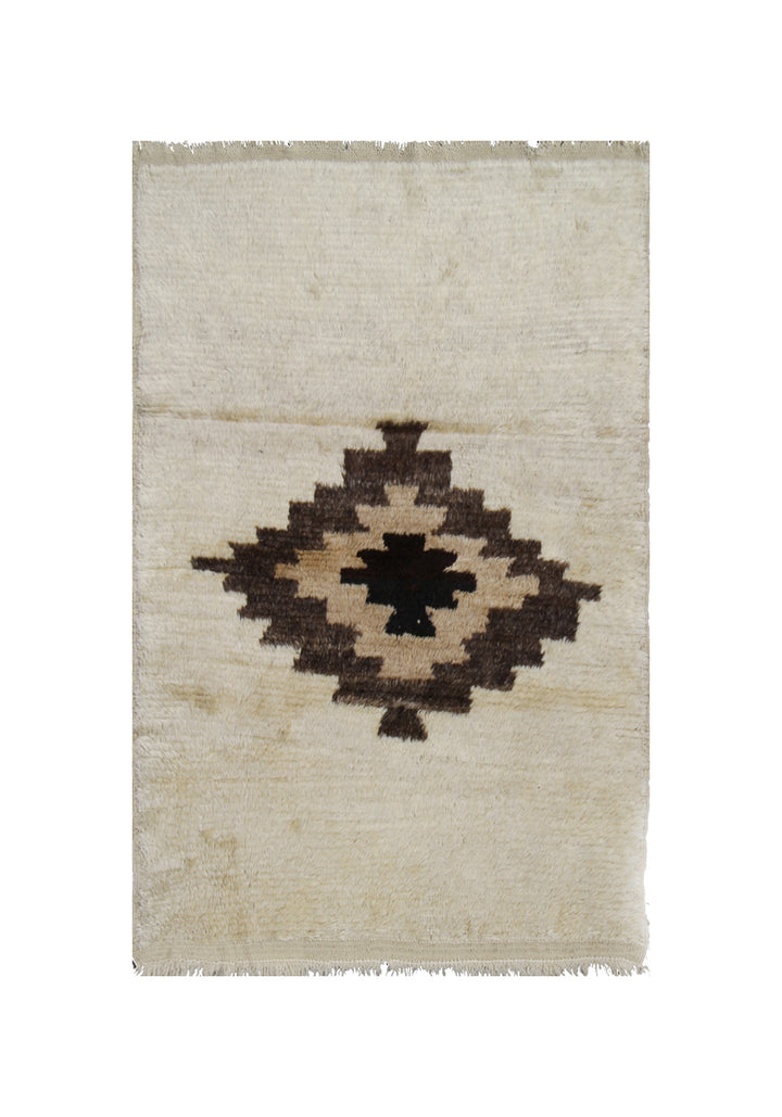 Beige rug with a central brown diamond pattern on a white background