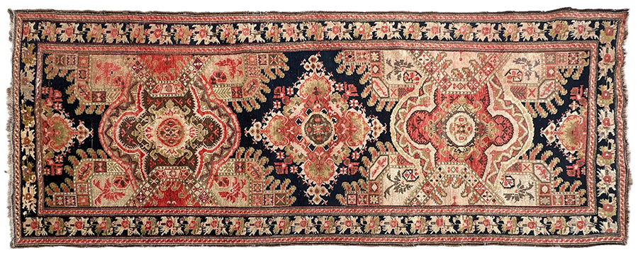 9'10" x 3'10" Antique Caucasian Karabagh wool runner rug featuring medallions and floral borders on a black background.