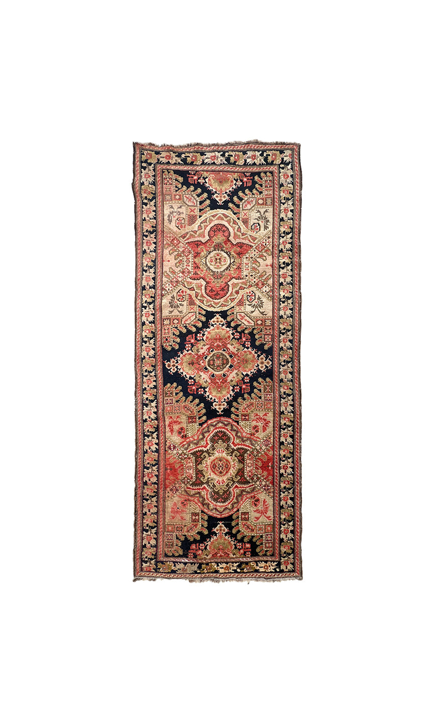 9'10" x 3'10" Antique Caucasian Karabagh wool runner rug featuring medallions and floral borders on a black background.