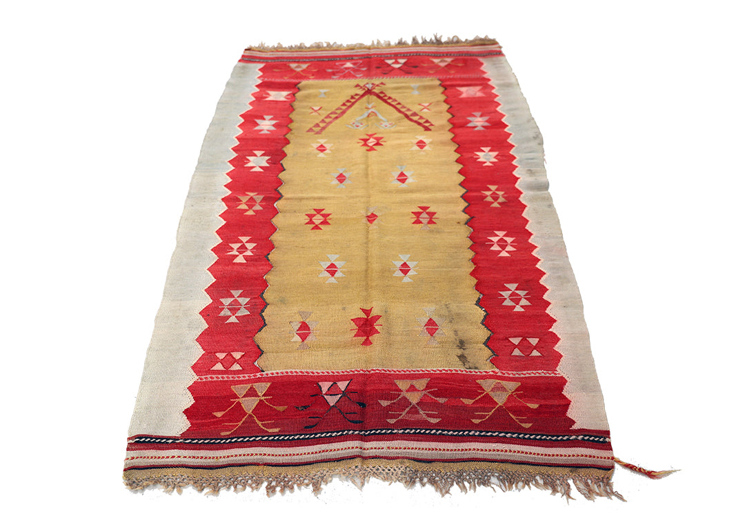 Traditional patterned rug with red and beige colors on a white background