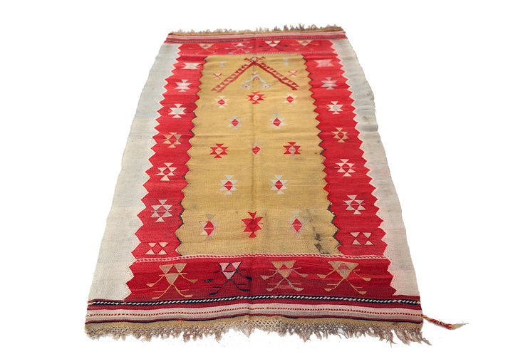 Traditional patterned rug with red and beige colors on a white background