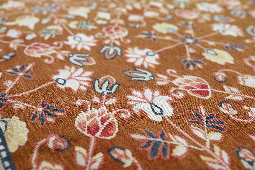 Close-up of floral fabric pattern on a brown background
