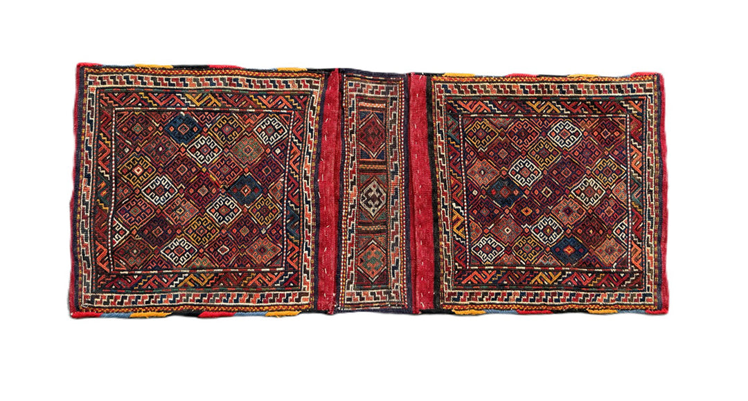 Handwoven Persian tribal storage saddle bag with geometric patterns in wool.