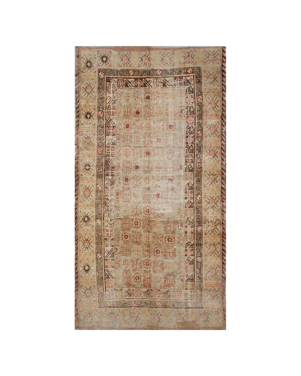 Decorative rug with intricate border design on a white background
