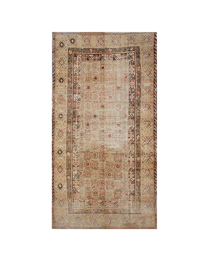 Decorative rug with intricate border design on a white background